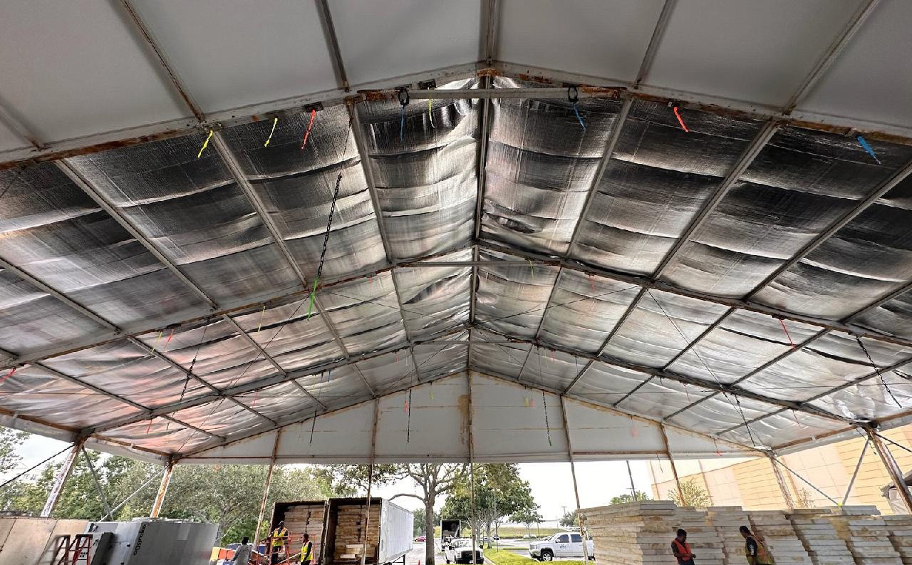 Reflective barrier installed under a large tent roof